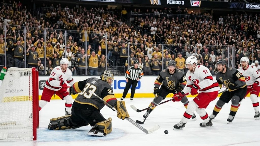 A dramatic ice-level perspective of the Vegas Golden Knights goalie defending the net against an attack by the Carolina Hurricanes, capturing the high stakes of a game 4 stanley cup matchup.