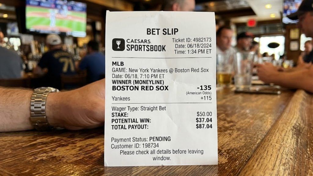 A close-up example of a physical Caesars Sportsbook bet slip demonstrating how to place a moneyline bet on an MLB game. The ticket details a $50.00 stake on the Boston Red Sox as a -135 favorite against the New York Yankees, showing a potential win of $37.04 and a total payout of $87.04.