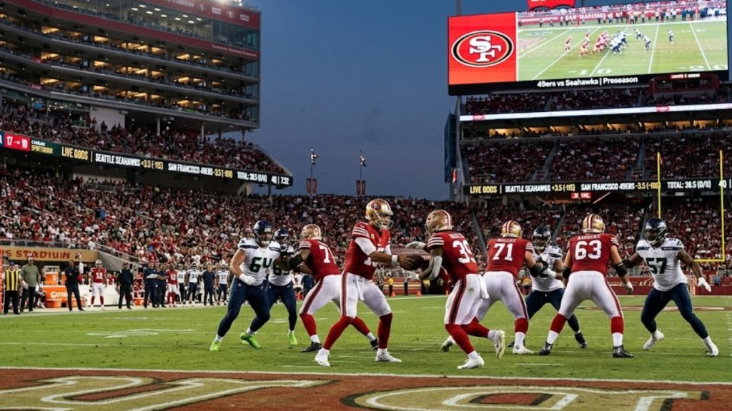 An NFL preseason game between the San Francisco 49ers and Seattle Seahawks in a stadium displaying live sportsbook betting odds for NFL preseason bets.